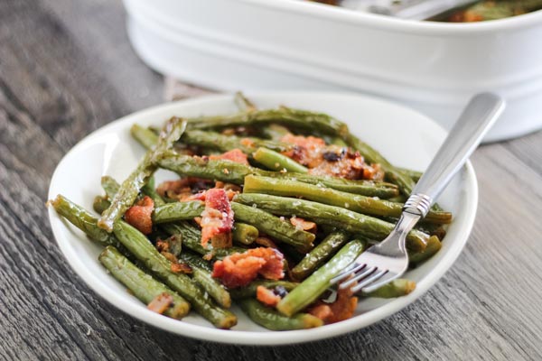 a plate with sauteed green beans and bacon on it
