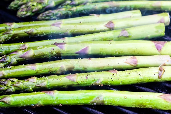 asparagus grilling on a grill grate