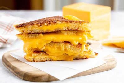 keto grilled cheese sandwiches on a wooden cutting board