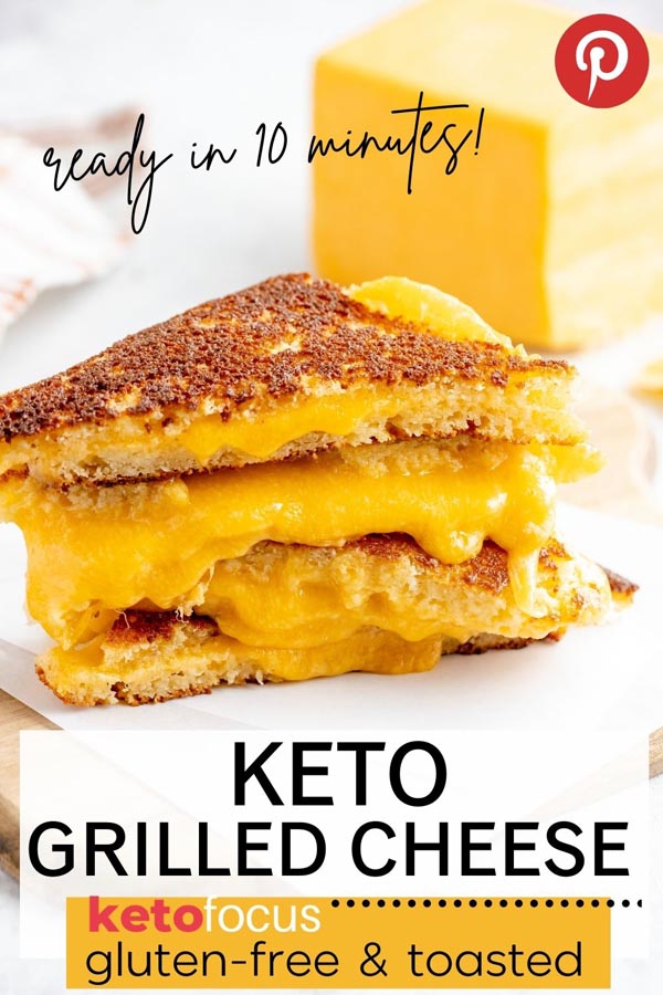 a stack of grilled cheese sandwiches with a block of cheddar behind