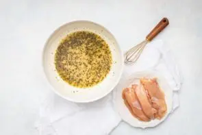 chicken marinade in a bowl with raw tenders next to it