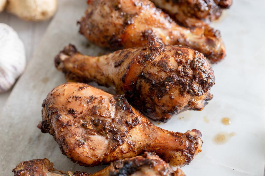 a bunch of grilled marinaded chicken legs
