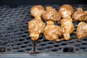 jerk marinaded chicken sitting on grill grate