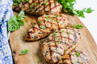 cross hatched grill chicken breast on a cutting board