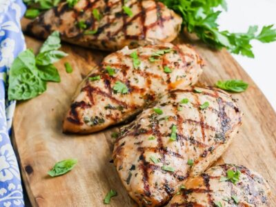 cross hatched grill chicken breast on a cutting board