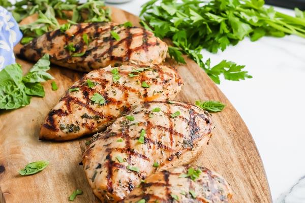 grilled chicken breast on a cutting board