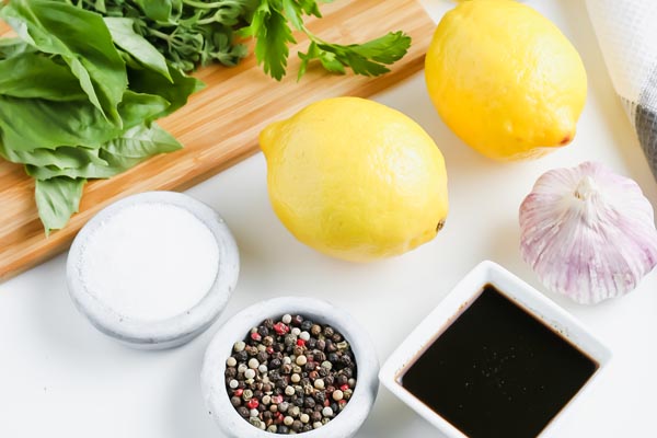 ingredients like lemons, pepper and worcestshire sauce in small bowls