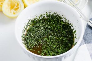 minced herbs sitting on top of a marinade