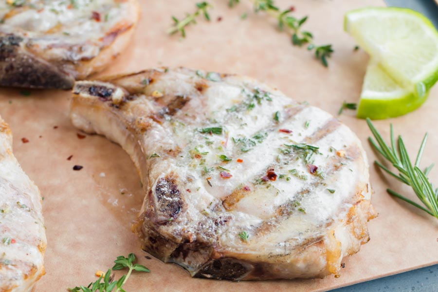 butter glistening off a grilled pork chop