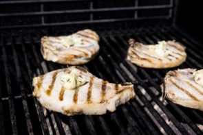 a dollup of compound butter mixture on top of each pork chop