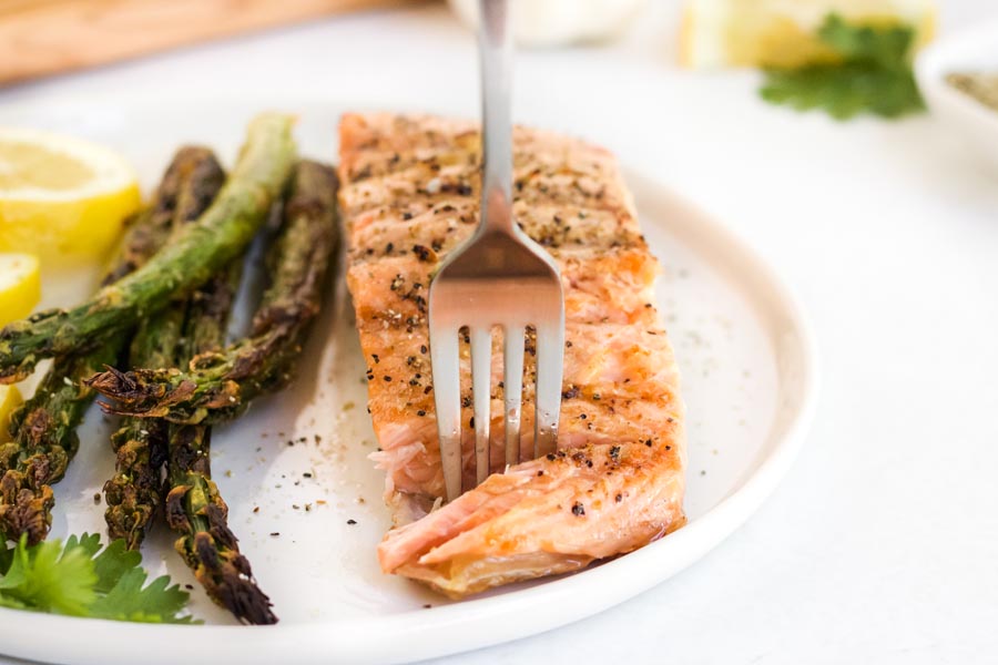 a fork stabbing into a bite of grilled keto salmon
