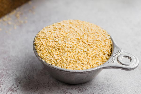 a cup of lupin meal in an old measuring cup