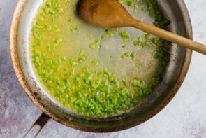 diced jalapeno cooking in a skillet with butter