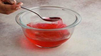 stirring red liquid mixture with a spoon