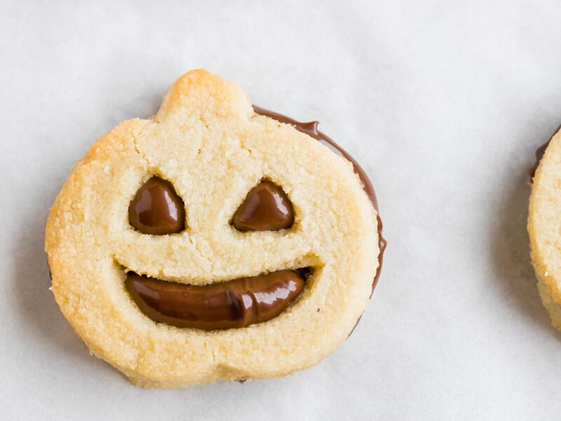 a cookie in the shape of a jack o lantern with a chocolate filling inside