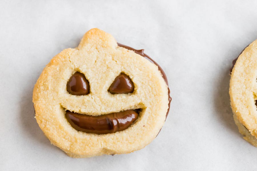 a cookie in the shape of a jack o lantern with a chocolate filling inside