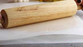 rolling cookie dough with a wooden rolling pin