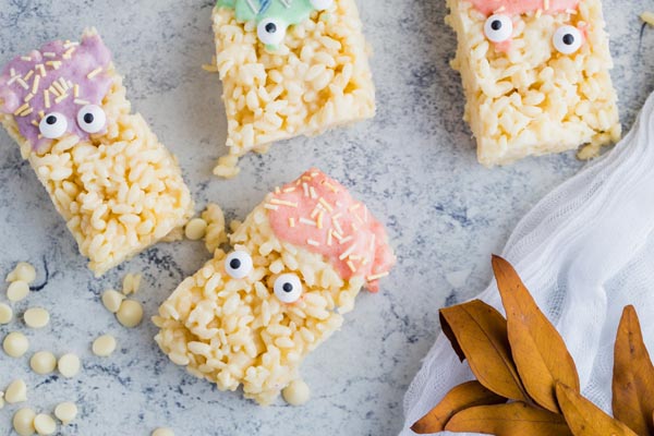 thick keto rice krispie treats with melted chocolate dripping and candy eyeballs
