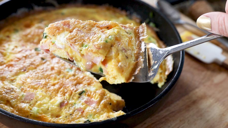 creamy frittata next to a skillet