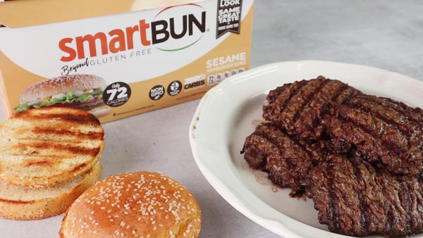 store bought smartbuns on the counter with some grilled burger patties