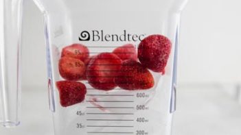 frozen strawberries and ice inside a blender