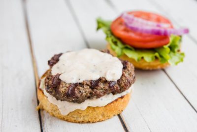 creamy keto horseradish sauce on a grilled burger and bun