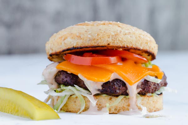 creamy thousand island dressing running down a keto hamburger