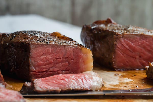 juicy steaks on a cutting board