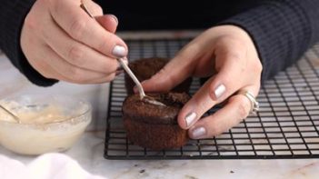 taking out the center of a cupcake with a spoon