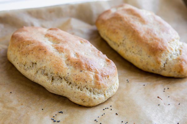 thick fluffy keto hot dog buns on a parchment lined tray