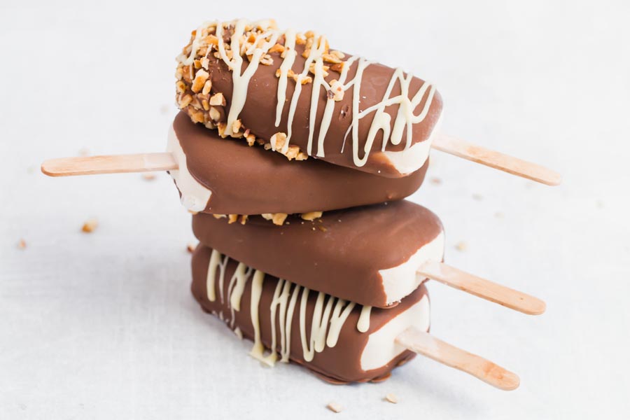 ice cream bars coated in sugar free chocolate scattered on the counter