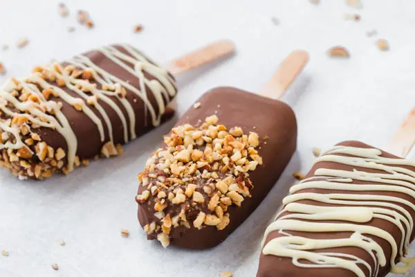 three keto chocolate covered ice cream bars in a row