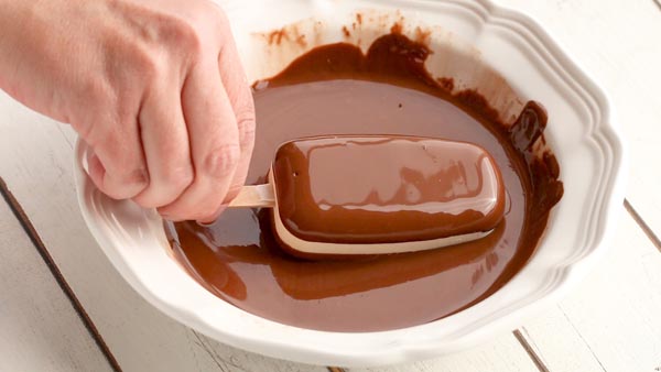dipping keto ice cream bars in chocolate coating