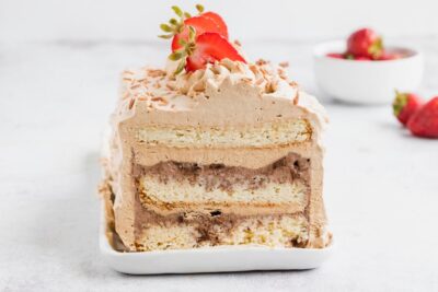 a sliced ice cream cake with layers of vanilla cake and chocolate ice cream