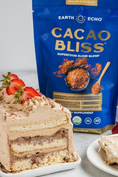 a sliced ice cream cake next to a bag of Cacao Bliss cocoa powder