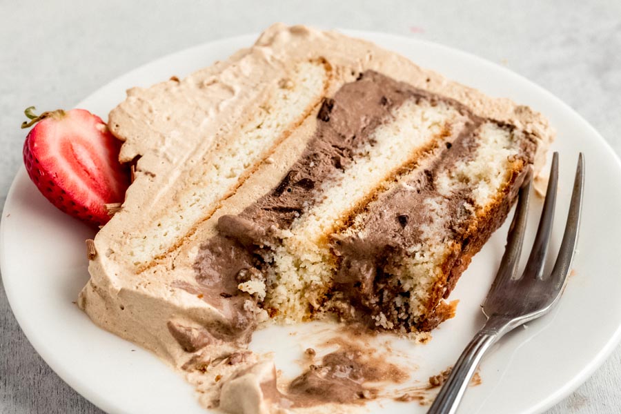 a bite out of a slice of ice cream cake with a fork to the side