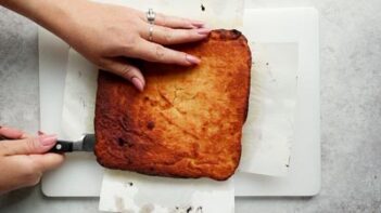 slicing a square cake through the center