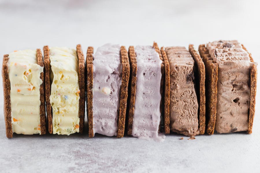 a long row of creamy ice cream sandwiches with different flavors