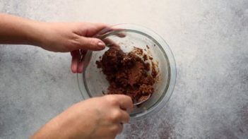 mixing chocolate cookie dough in a small bowl