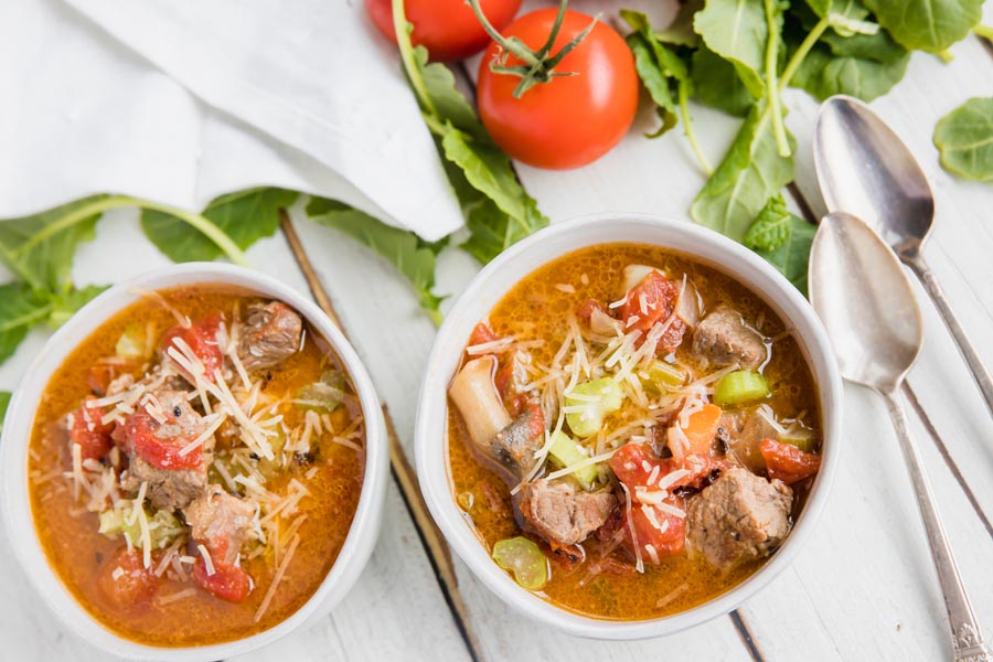 overhead view of two bowls of soup with spoons