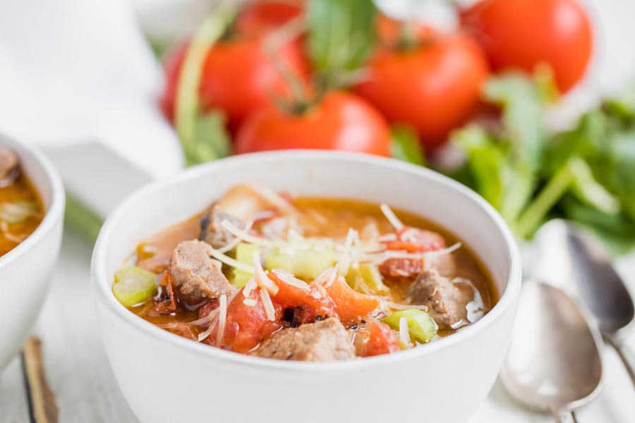 hearty bowl of stew with bright vegetables and stew meat