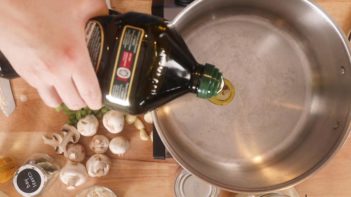 pouring olive oil into a dutch oven