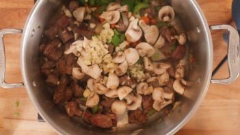 raw mushrooms and tons of minced garlic added to a stock pot