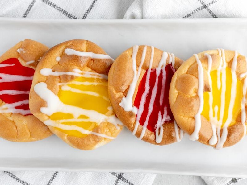 a white plate with four danishes on top