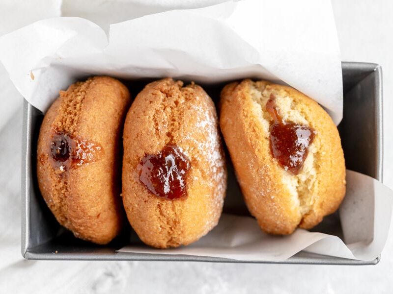 three donuts in a baking loaf pan wrapped in parchment paper