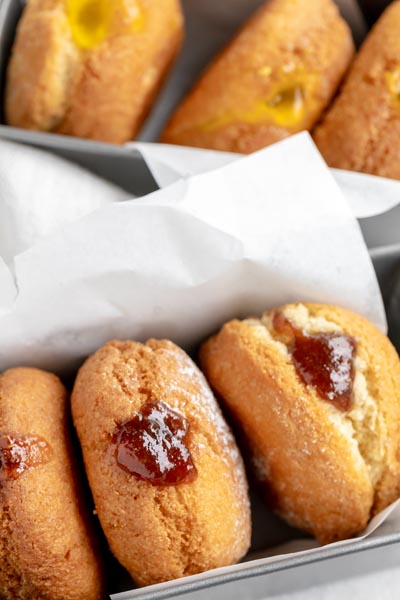 donuts in a row filled with a strawberry jam