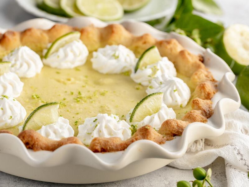 a whole lime pie in a white pie plate