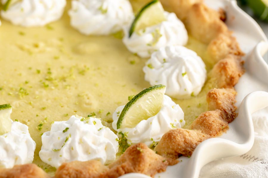 close up of the flaky pie crust on a key lime pie