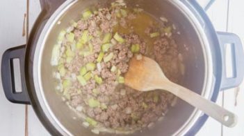 ground beef and celery cooking on saute mode in the instant pot