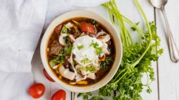 dollup of ricotta cheese and mozzarella cheese sprinkled on keto lasagna soup in a bowl